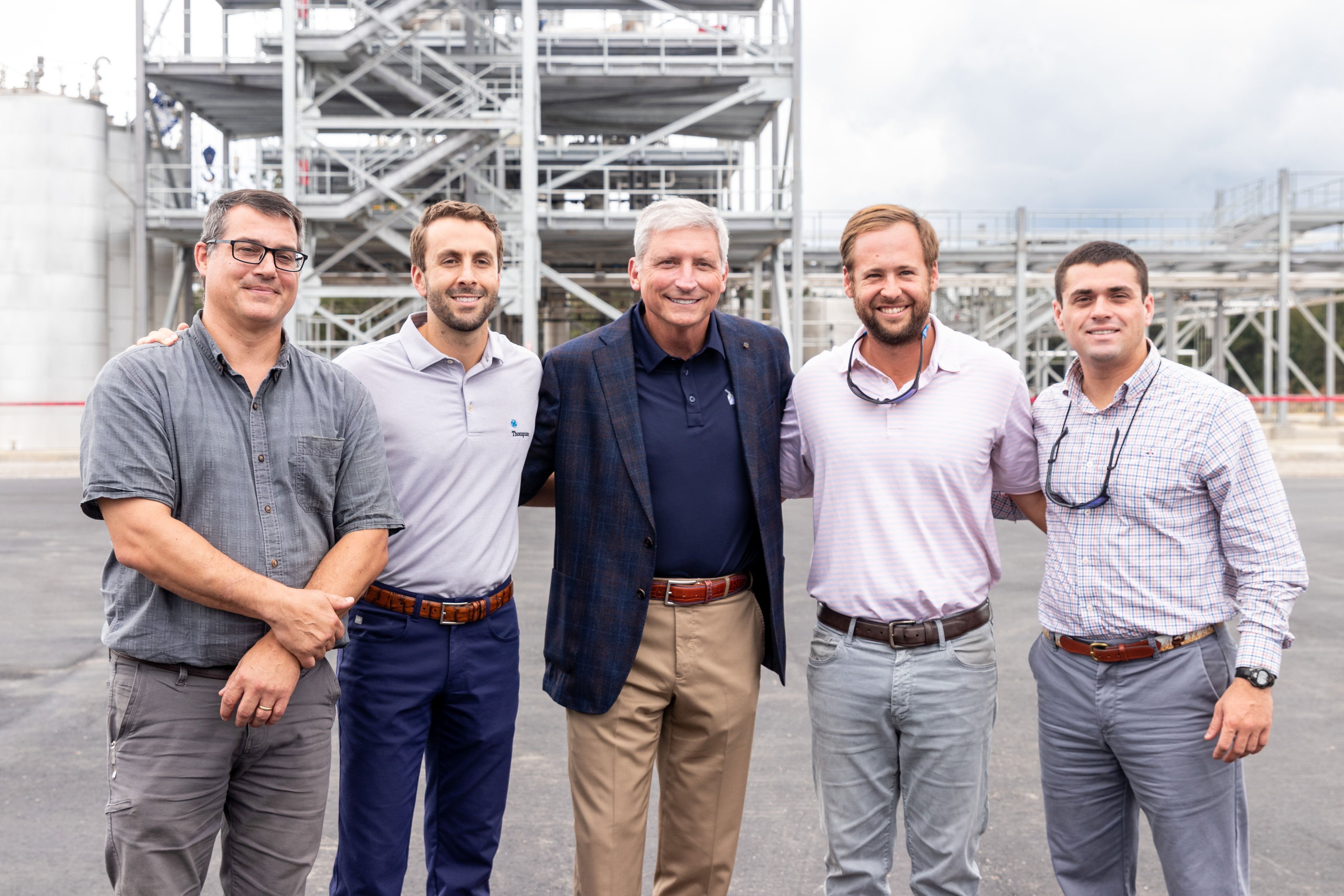 Leadership from Thompson Construction in front of a steel frame building in South Carolina. 